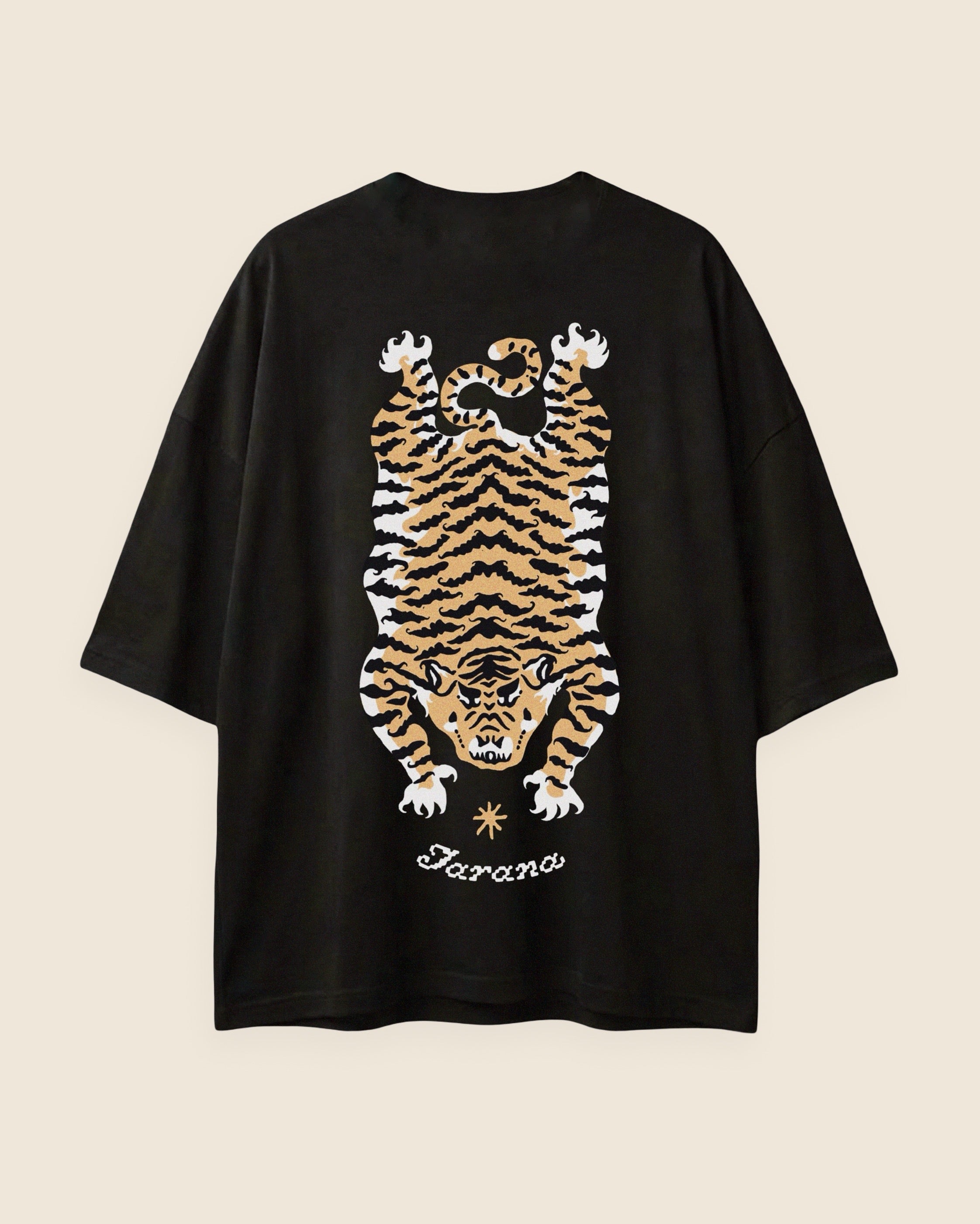 Black t-shirt with a tiger graphic and 'Jarana' branding on a beige background