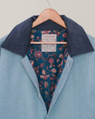 Close-up of blockprinted floral lining inside handmade blue denim-inspired Jarana jacket