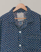 Close-up of collar and label of blue Jarana shirt, featuring detailed Kantha hand embroidery