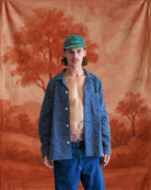 Model wearing an open handmade Kantha shirt in blue with floral block print embroidery