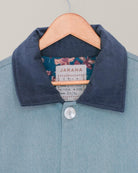 Close-up of blockprinted floral lining inside handmade blue denim-inspired Jarana jacket