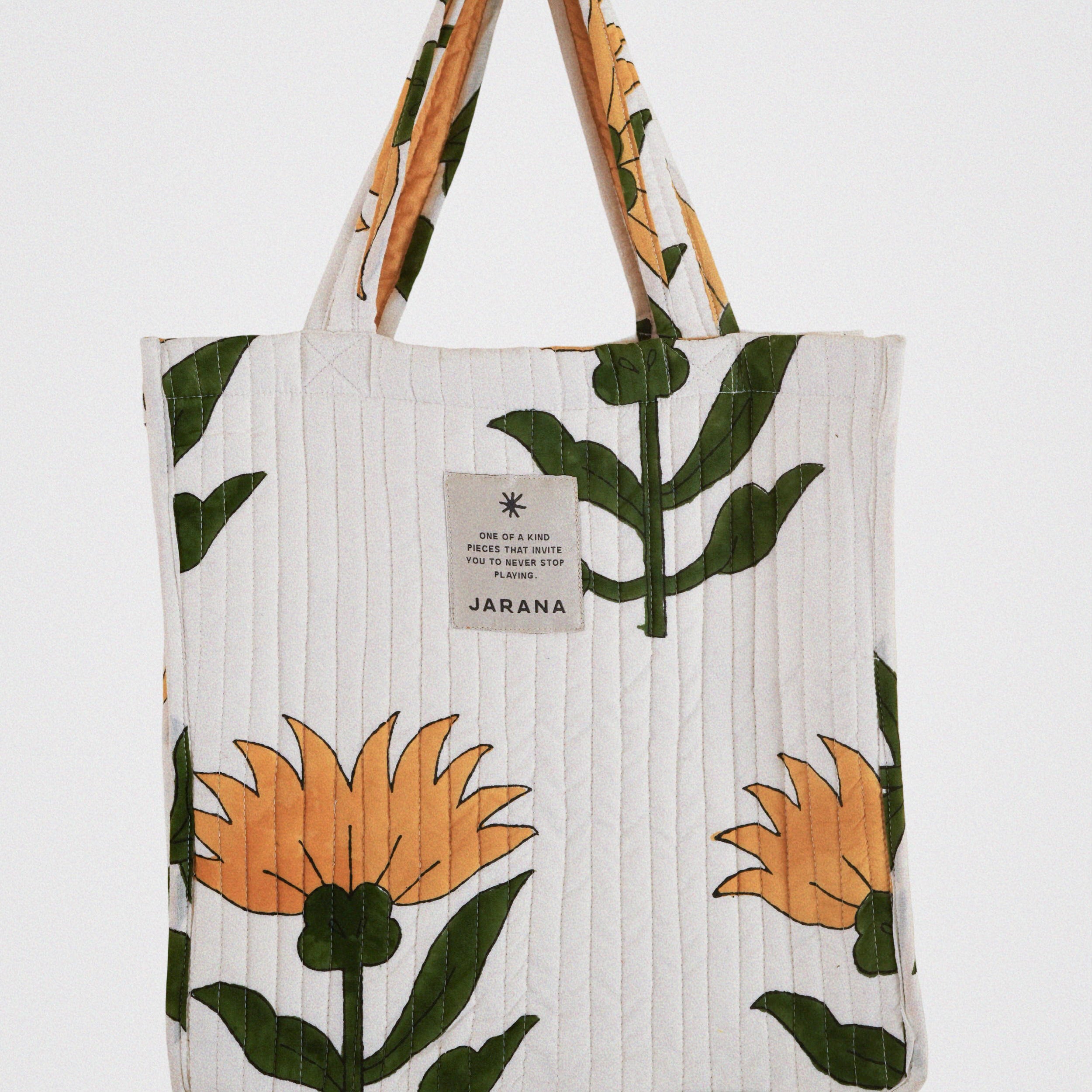 Hand-quilted tote bag with oversized yellow flower block print, featuring inner pocket and upcycled cotton.
