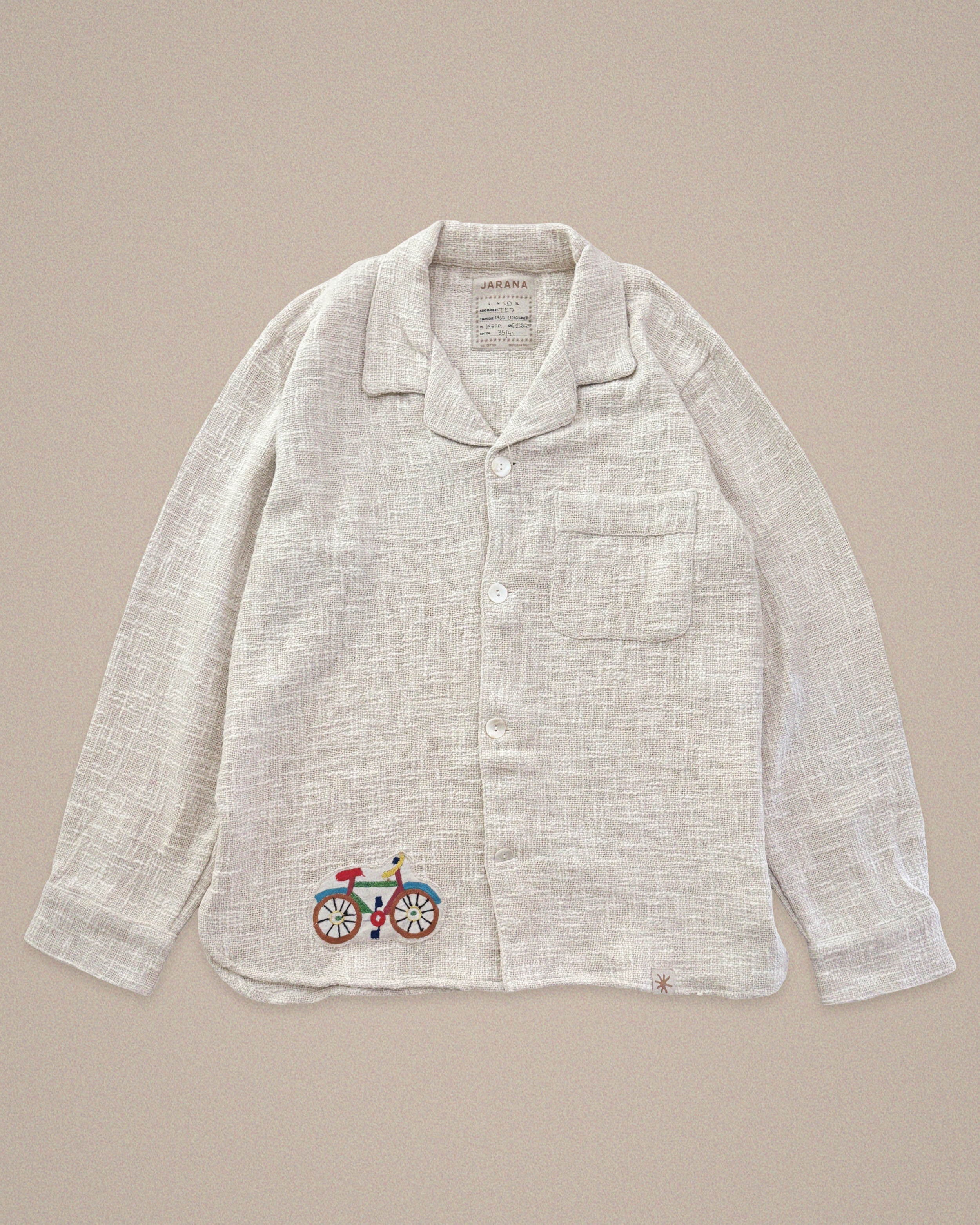 Handmade linen shirt with bicycle embroidery β playful detail on light textile by Jarana