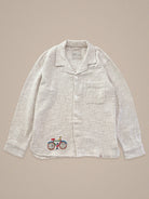 Handmade linen shirt with bicycle embroidery β playful detail on light textile by Jarana