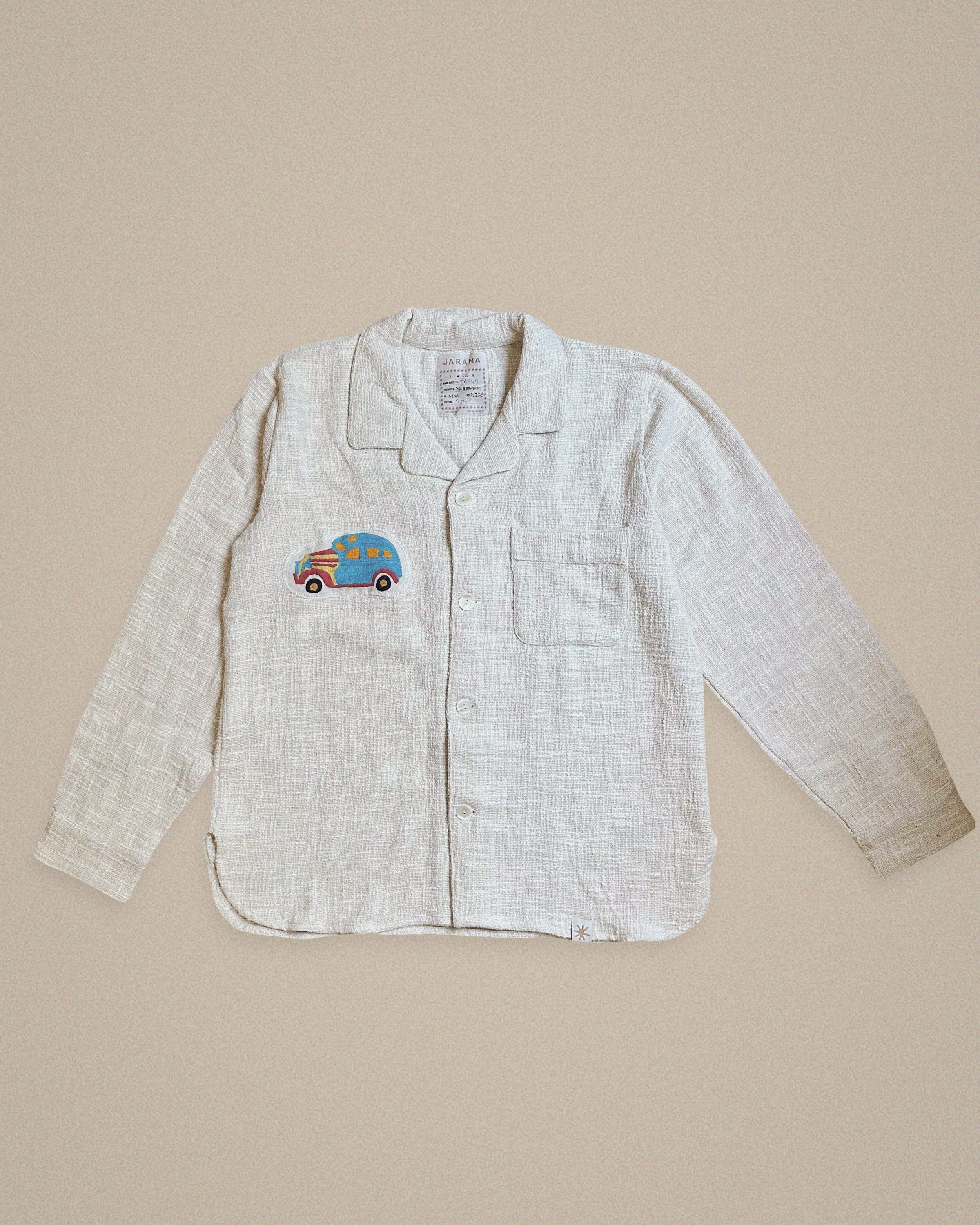 Handmade linen shirt with blue embroidered vintage car β whimsical design on textured fabric by Jarana