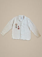 Handmade linen shirt with colorful palm tree and musical figure embroidery β playful Indian motif by Jarana