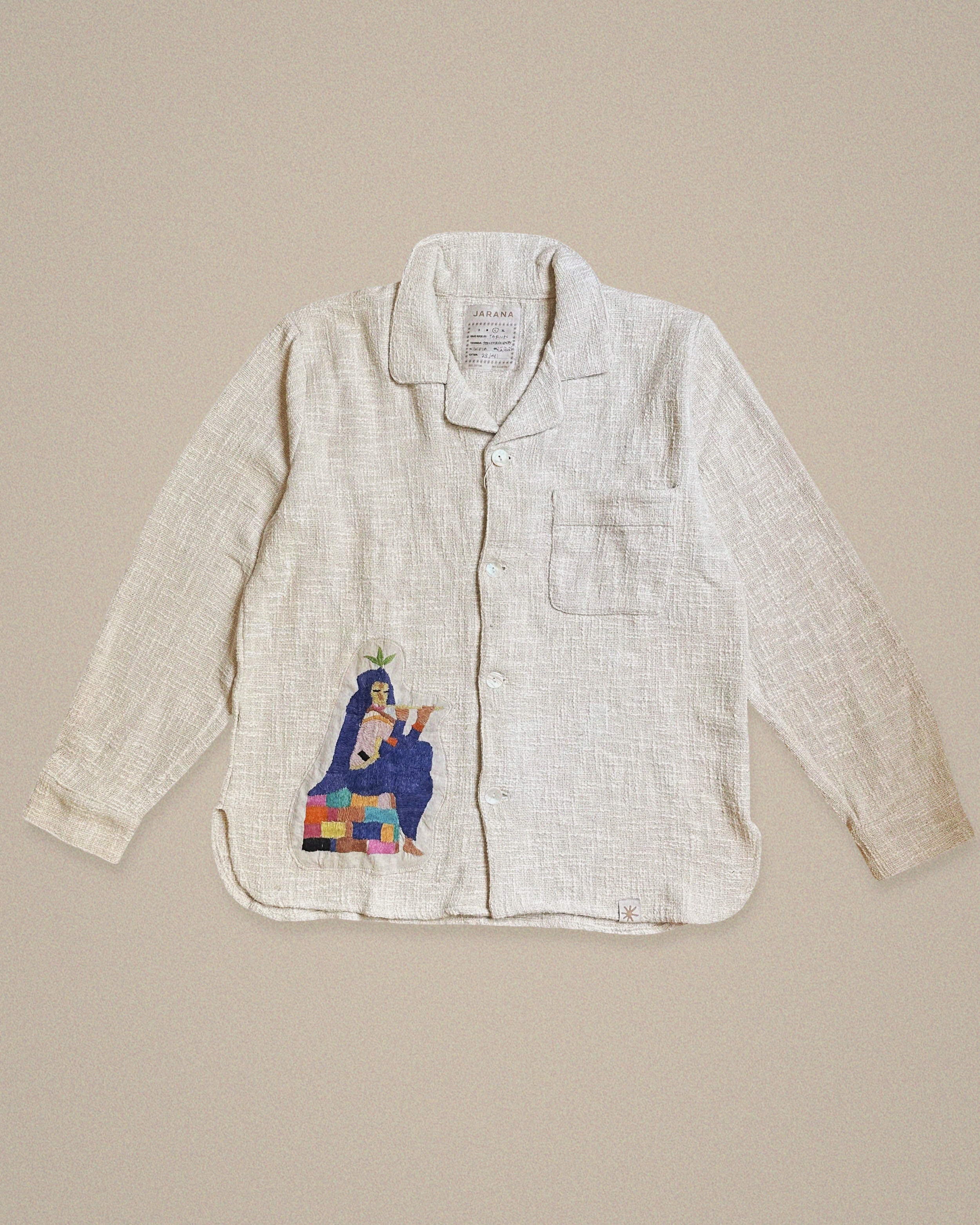 Handmade linen shirt featuring a seated Krishna figure with a plant headdress β crafted from vintage textiles by Jarana