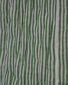Macro detail of green and white striped blockprint fabric on quilted cotton jacket surface