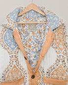 Interior of blockprinted quilted cotton jacket showing floral patterned lining and visible Jarana label
