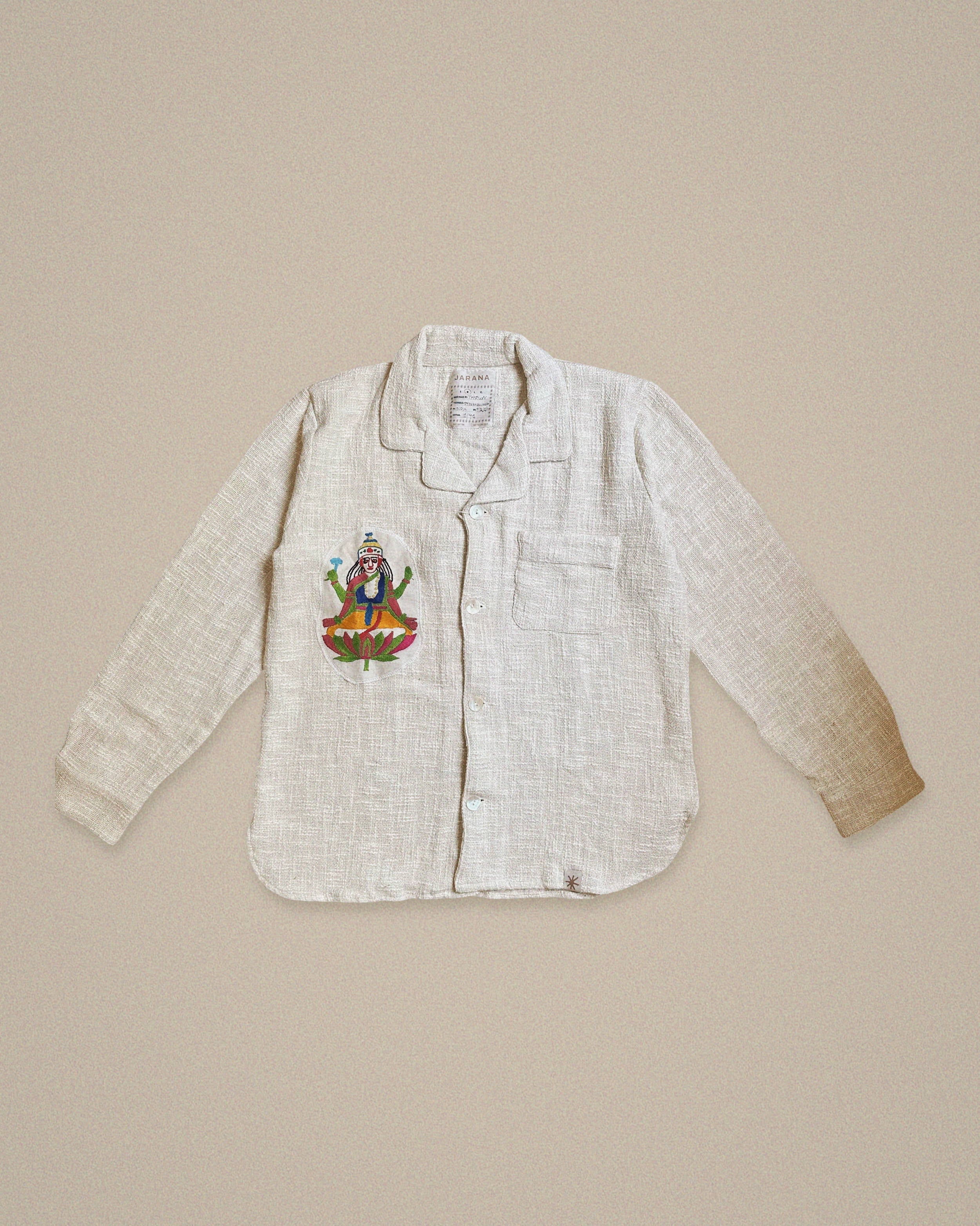 Handmade cotton shirt with embroidered depiction of Shiva sitting on a lotus β vibrant Jarana spiritual design