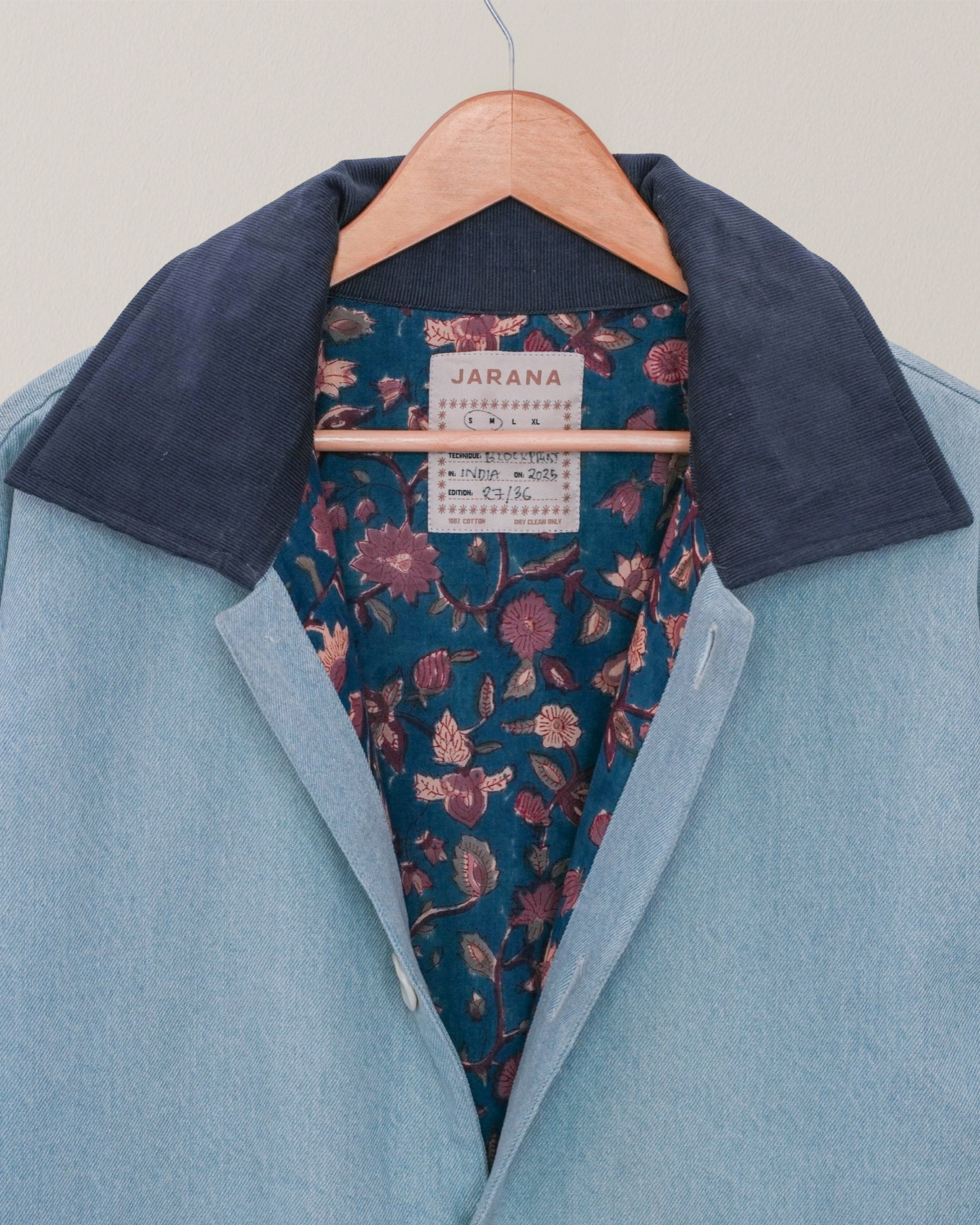 Close-up of blockprinted floral lining inside handmade blue denim-inspired Jarana jacket