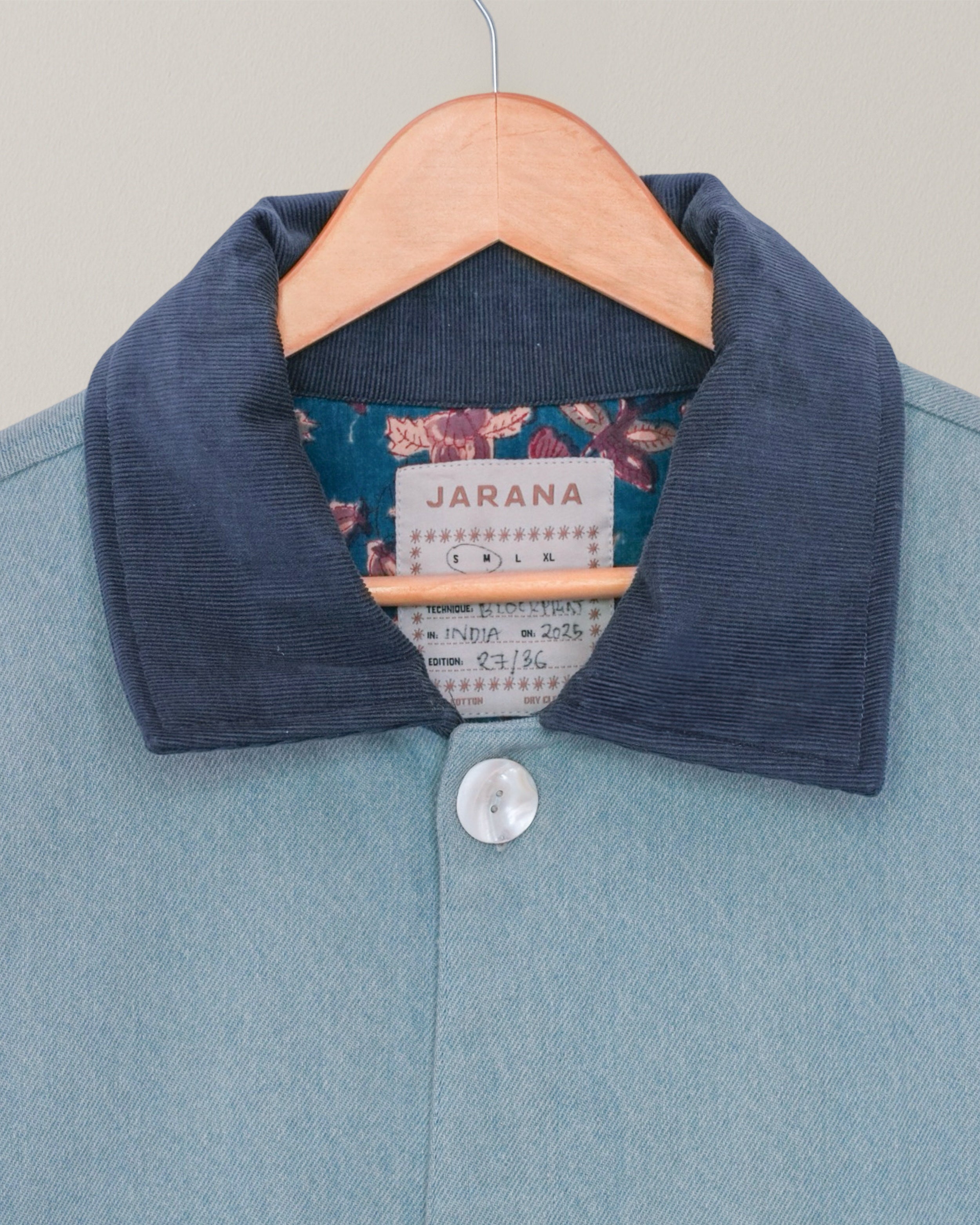 Close-up of blockprinted floral lining inside handmade blue denim-inspired Jarana jacket