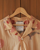 Detail of resort collar and Jarana label with red flower motif peeking from inside neckline.