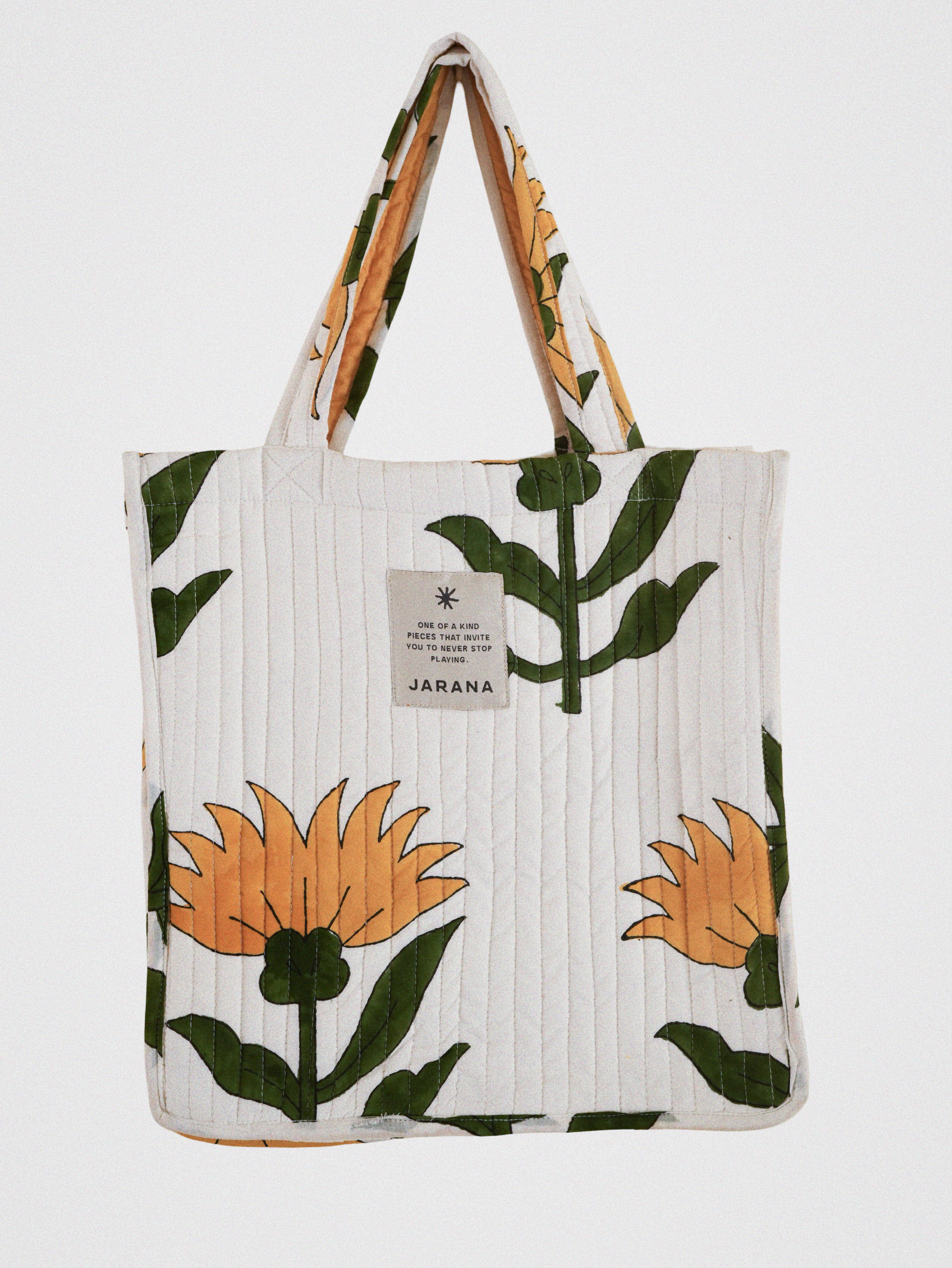 Hand-quilted tote bag with oversized yellow flower block print, featuring inner pocket and upcycled cotton.