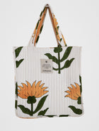 Hand-quilted tote bag with oversized yellow flower block print, featuring inner pocket and upcycled cotton.