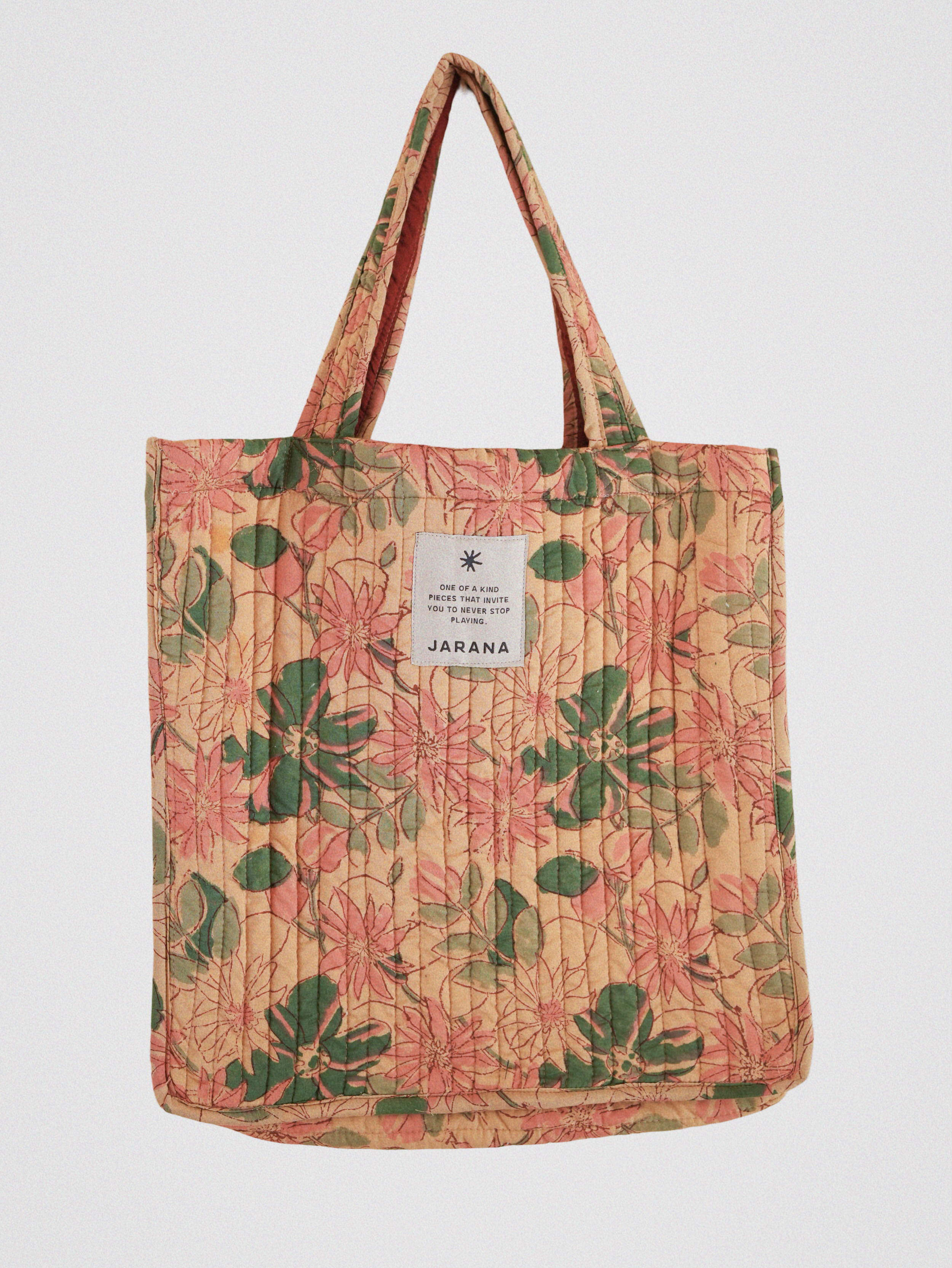 Peach-toned quilted tote bag featuring vintage floral block print in green and pink, handcrafted in India by Jarana.