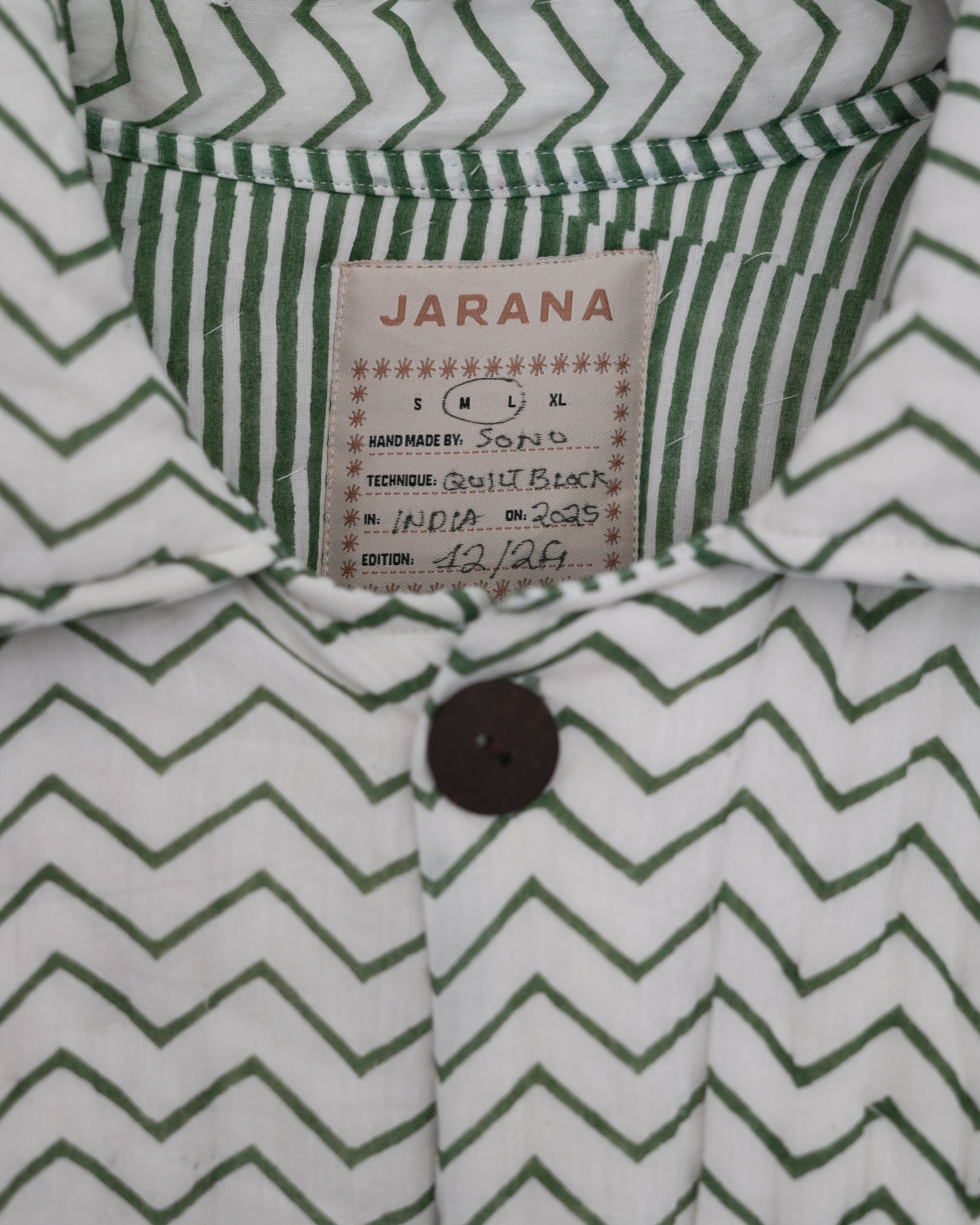 Close-up of green striped collar and inner floral of reversible blockprinted quilted cotton jacket