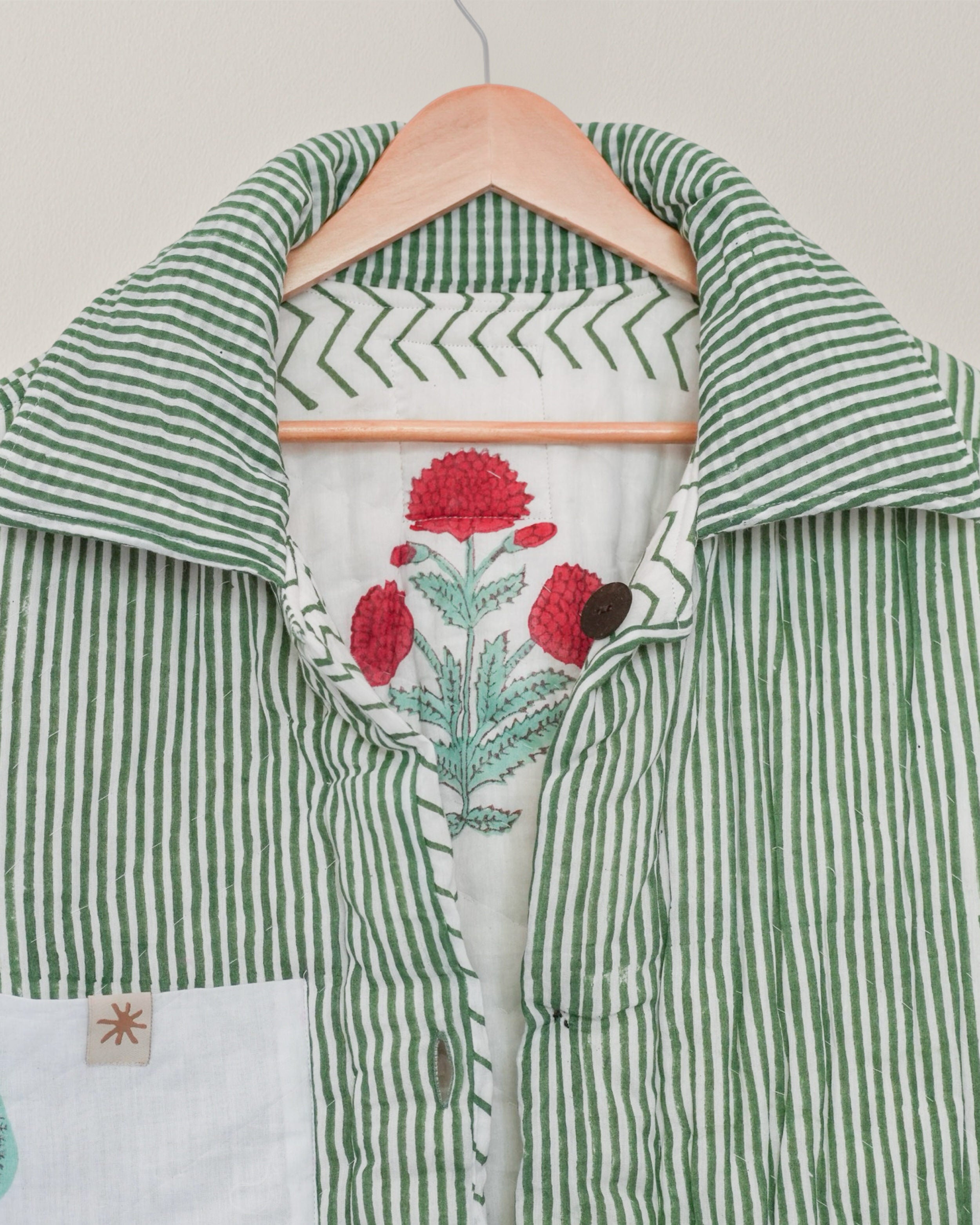 Close-up of green striped collar and inner floral of reversible blockprinted quilted cotton jacket